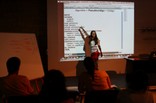 Angela explaining programming to some collaborators - thumbnail